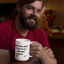 15-oz-mug-mockup-featuring-a-bearded-man-in-a-cozy-room-with-fall-decorations-29156